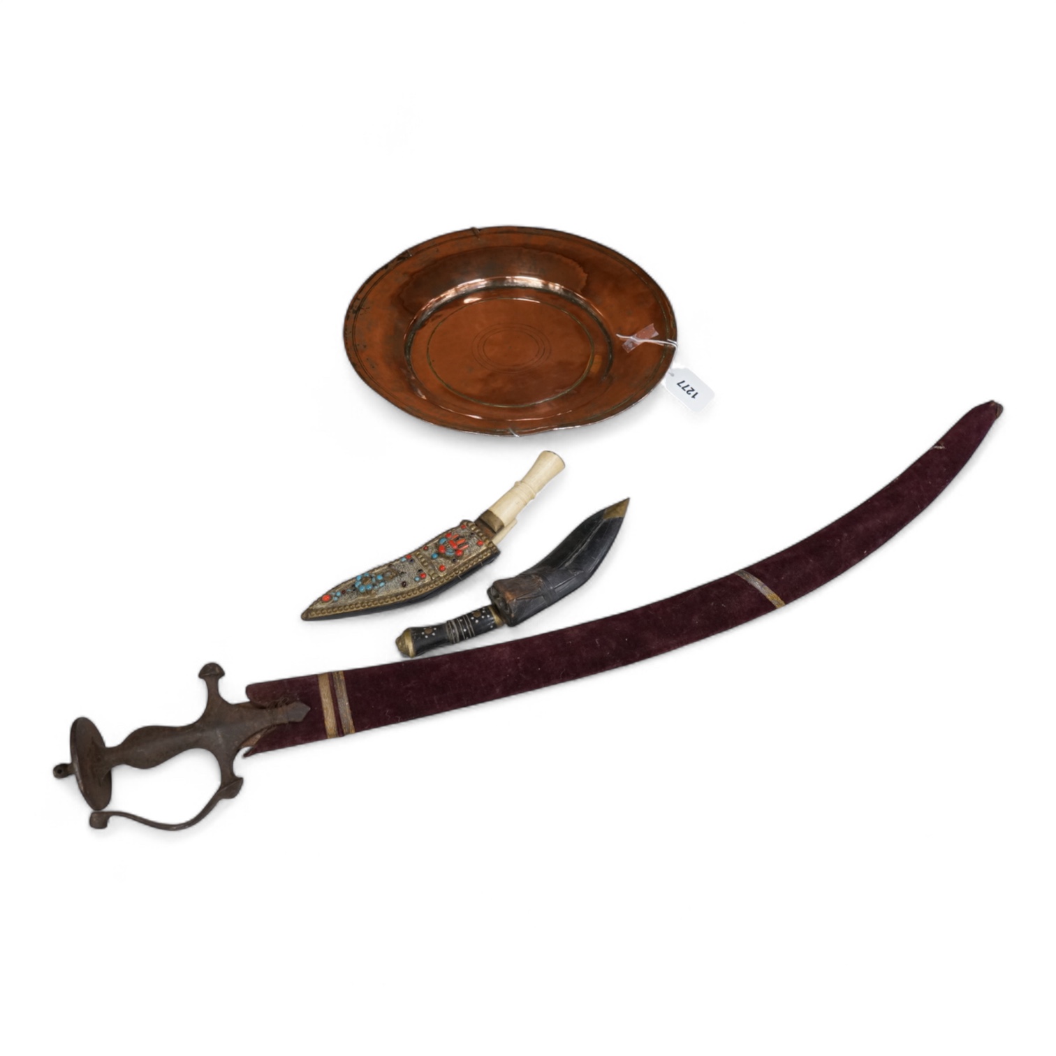 An Indian Tulwar sword, in scabbard and two small kukri, largest 93cm long.